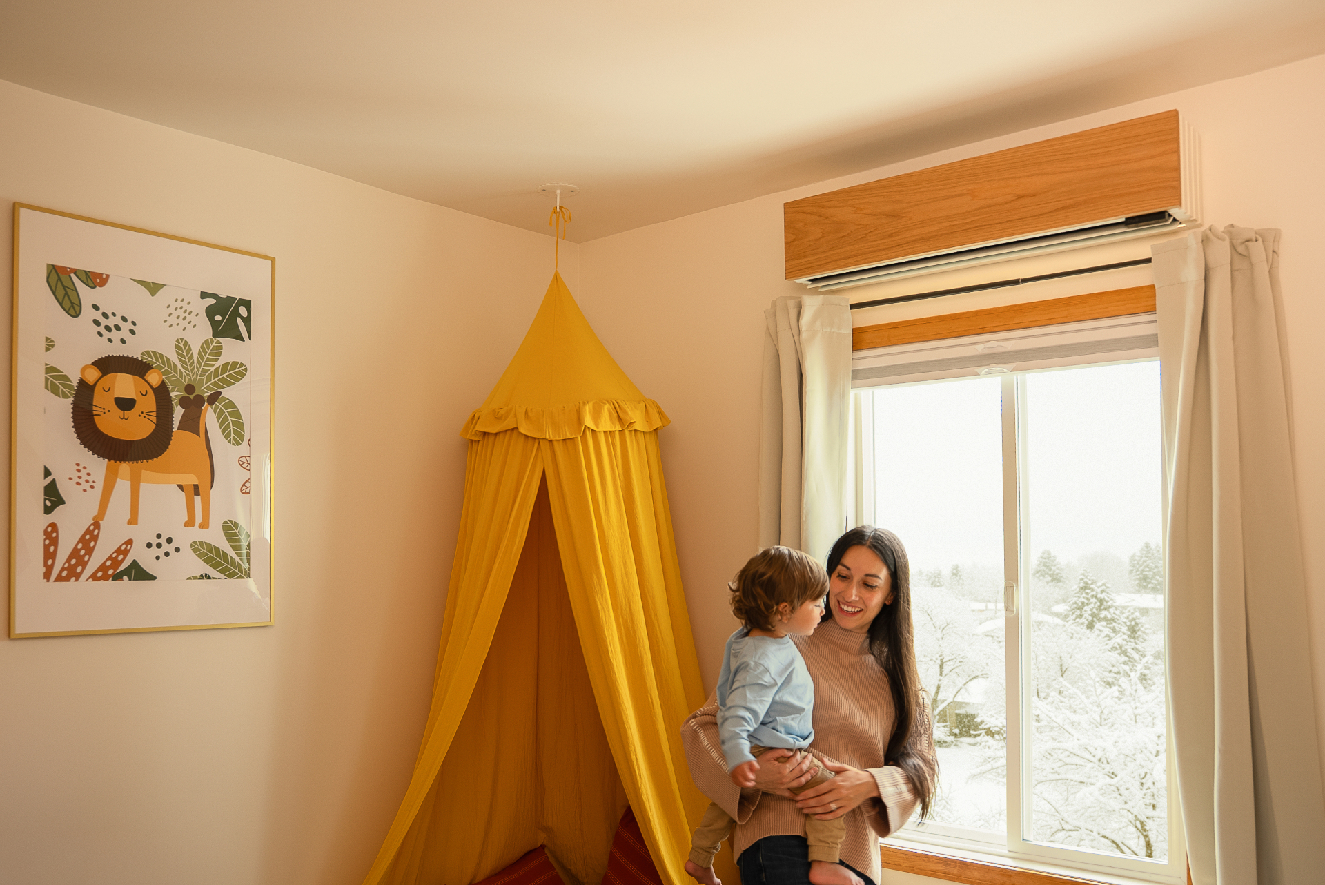 Mother and child in a cozy room with a heat pump