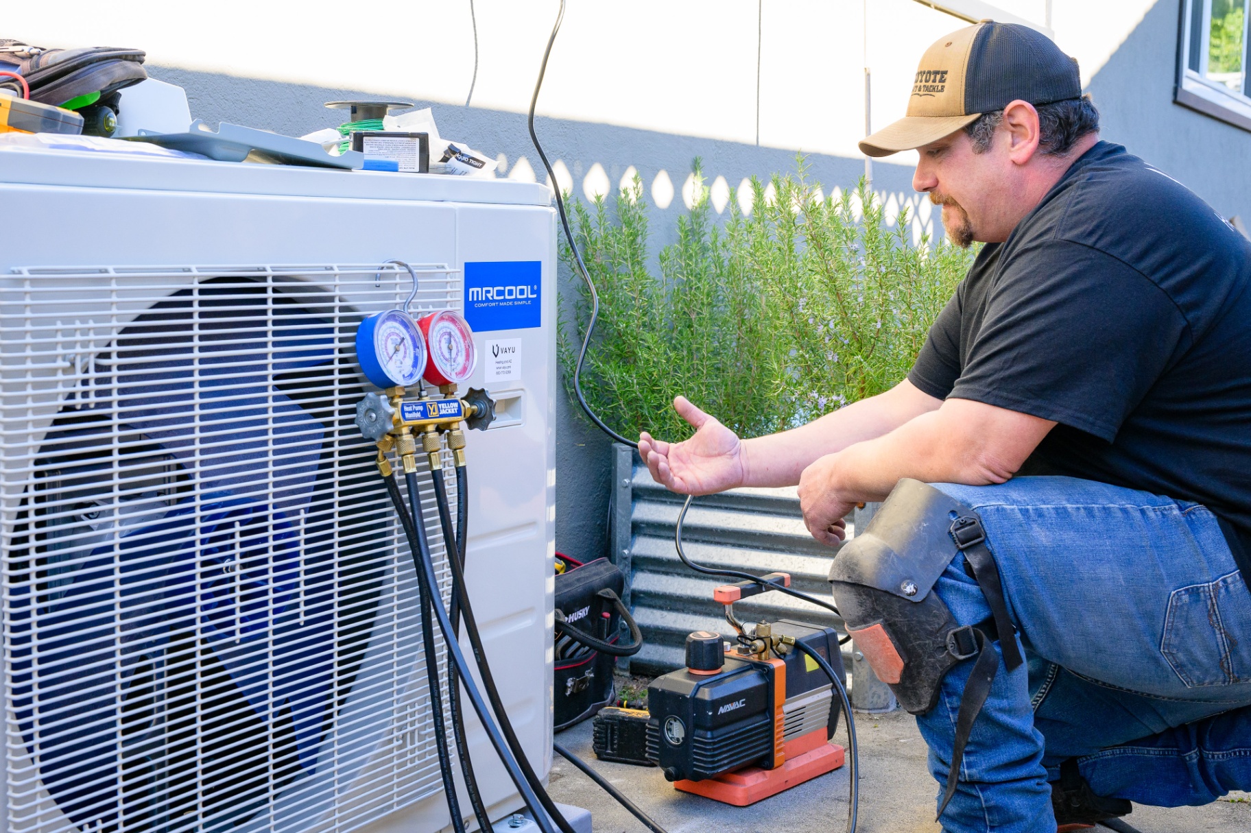 HVAC technician servicing a heat pump outdoor unit